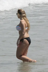 Big boobed thick blonde on the beach in a bikini