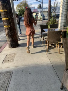 Street candid girl with hot legs in a short dress