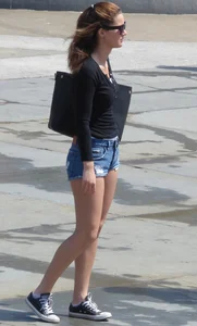 Cute girl with nice legs in short denim shorts