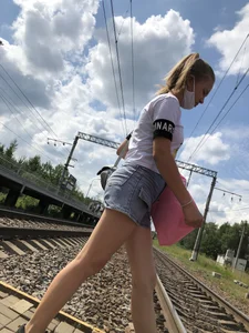 Cute Girl in Denim Shorts Walking Down a Railway Station Gallery