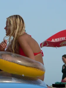 Sexy mom and daughter in red thongs at the beach