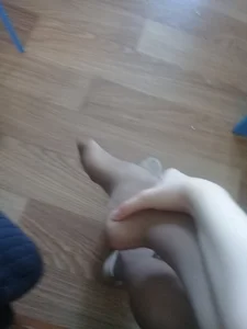Young Candid Girl in Pantyhose Holding Her Foot in Her Hand