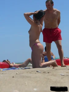 Purple thong topless lady on the beach gets oiled up by her husband