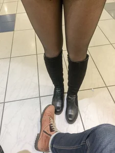 Closeup of awesome legs in black pantyhose and boots