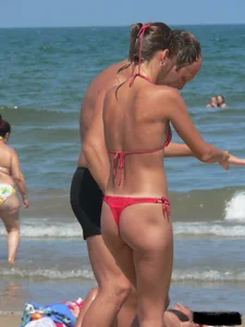 A bunch of hot babes on the beach in thong bikinis