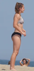 Sexy blonde girl on the beach in a bikini with nice legs, ass and stomach