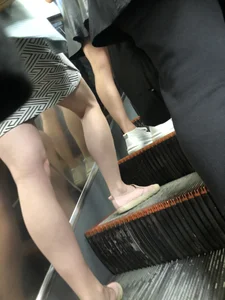 Candid Legs in a Skirt on a Subway Escalator Closeup
