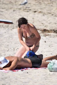 Brunette on the beach in a cheetah print bikini