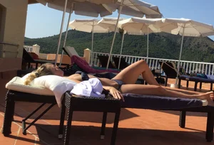 Blonde laying out in a blue bikini with a sexy body