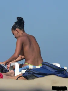 Hot ass topless beach girl with great tits lets her little brother oil up her ass in thong bikini