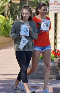 Brunette in tiny shorts walking with her sexy friend in leggings