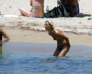 Small boobed topless milf on the beach