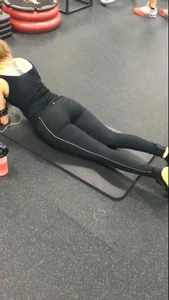 Sexy gym girl with a nice body in leggings as she works out