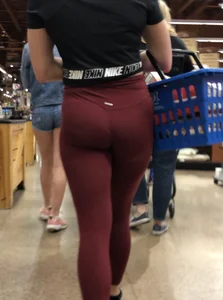 Girl with a nice ass in maroon leggings shopping