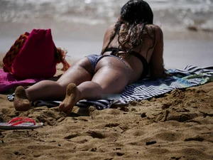 Sexy ass brunette with a perfect body in bikini on the beach