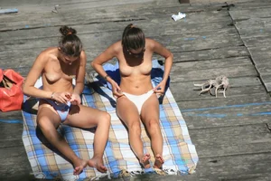 Two teens stripping and going topless to tan