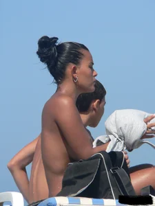 Hot ass topless beach girl with great tits lets her little brother oil up her ass in thong bikini
