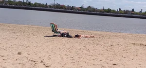 Girl laying out getting sun in a white thong bikini