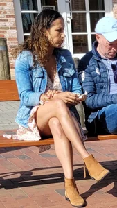 Canid milf in a dress with nice crossed legs sitting on a bench