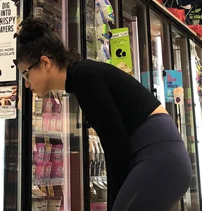 Girl with glasses shopping in leggings showing her VPL