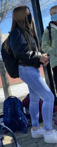 A Cute Masked Girl in Blue Jeans at the Bus Stop Street Creepshot