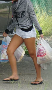 Girl next door teen neighbor bringing in groceries in short jean shorts