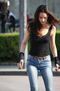 Hot brunette skateboarder in tight jeans and with hard nipples
