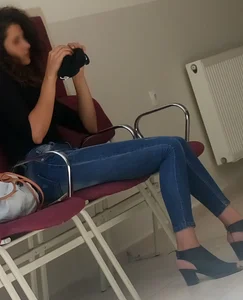 A Skinny Girl in Shoes With Heels And Tight Blue Jeans Sitting With Crossed Legs, Creepshot at the Public Library