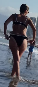 Milf with a big booty in a bikini at the beach