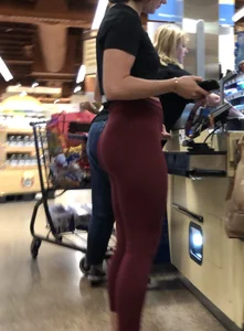 Girl with a nice ass in maroon leggings shopping