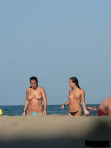 2 topless thonged sexy friends on the beach with great bodies