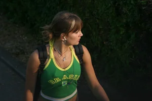 Pretty girl playing tennis in a skirt and walking in jeans
