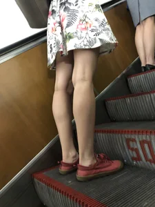 Skinny Legs of a Blue Haired Girl on a Subway Escalator Closeup Creepshots