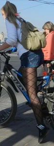 Blonde Teen Riding a Bike in Shorts
