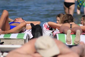 A couple sexy girls laying out on the beach