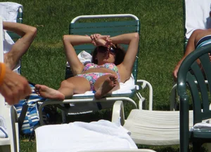 Cute brunette at the pool in a floral bikini