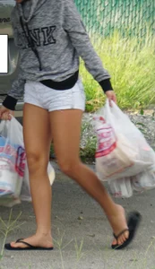 Girl next door teen neighbor bringing in groceries in short jean shorts