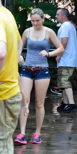 Cute blonde in denim shorts and a wet top