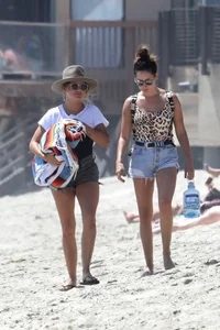 Ashley Tisdale in cheetah print swimsuit on the beach in Malibu