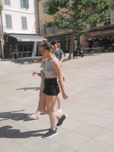 Cute babe in short black denim shorts and tank top