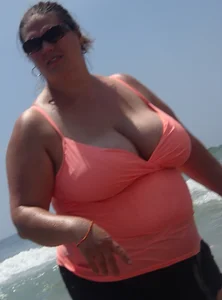 Thick lady on the beach with huge tits