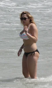 Big boobed thick blonde on the beach in a bikini
