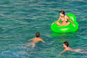 FKK Nudists playing in the water with floater
