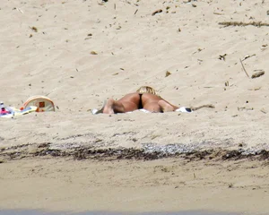 Small boobed topless milf on the beach