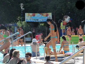 Tall and skinny brunette babe at the pool in a teal thong bikini