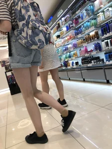 Girl in Blue Denim Shorts with Very Skinny Legs Store Candid