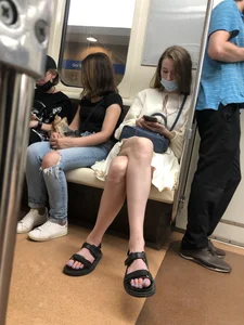 Masked Girl in a Dress and Sandals Sitting With Crossed Legs in a Subway Train Creepshots