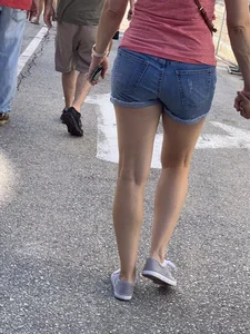 Bunch of girls in various outfits at a Cardinals baseball game