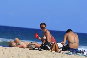 Sexy girls topless on a nude beach showing their nice tits