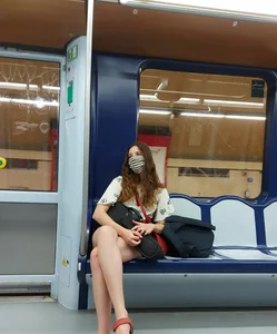 Sexy Girl in a Mask Sitting With Crossed Legs in a Subway Train Creepshot